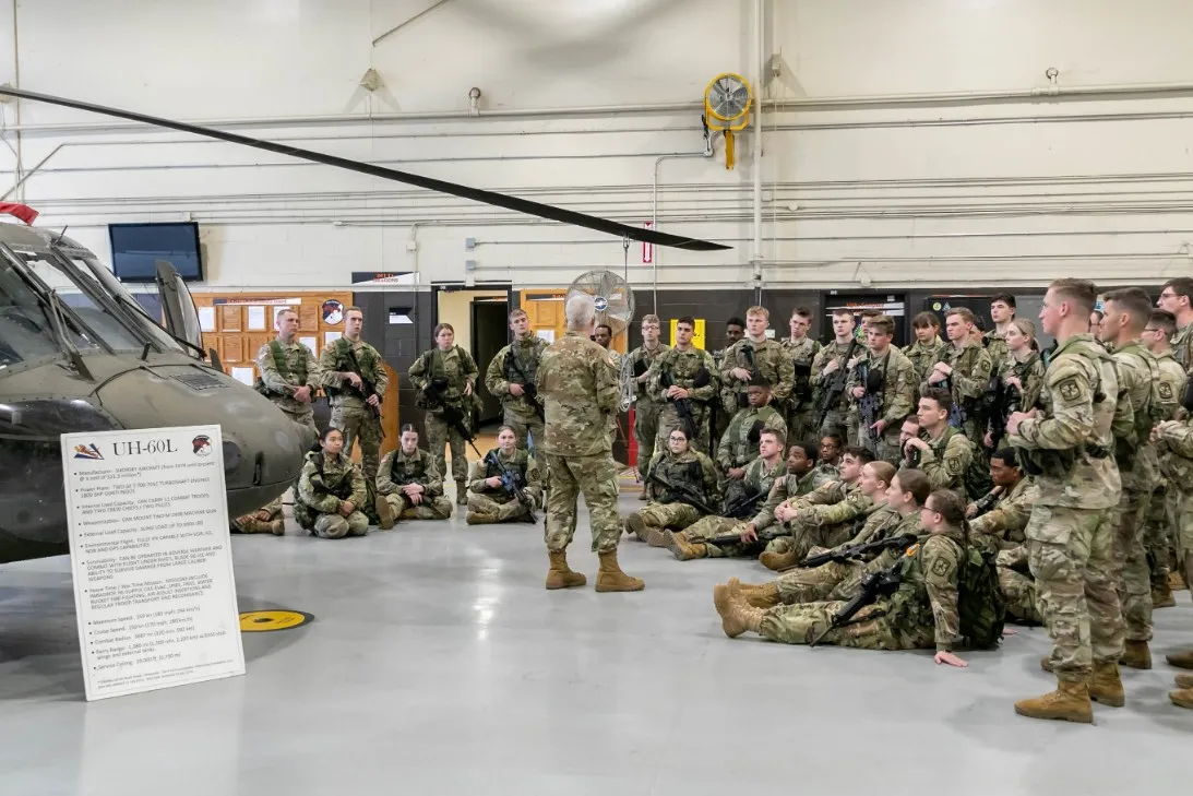 Army ROTC cadets training beside a UH-60 helicopter