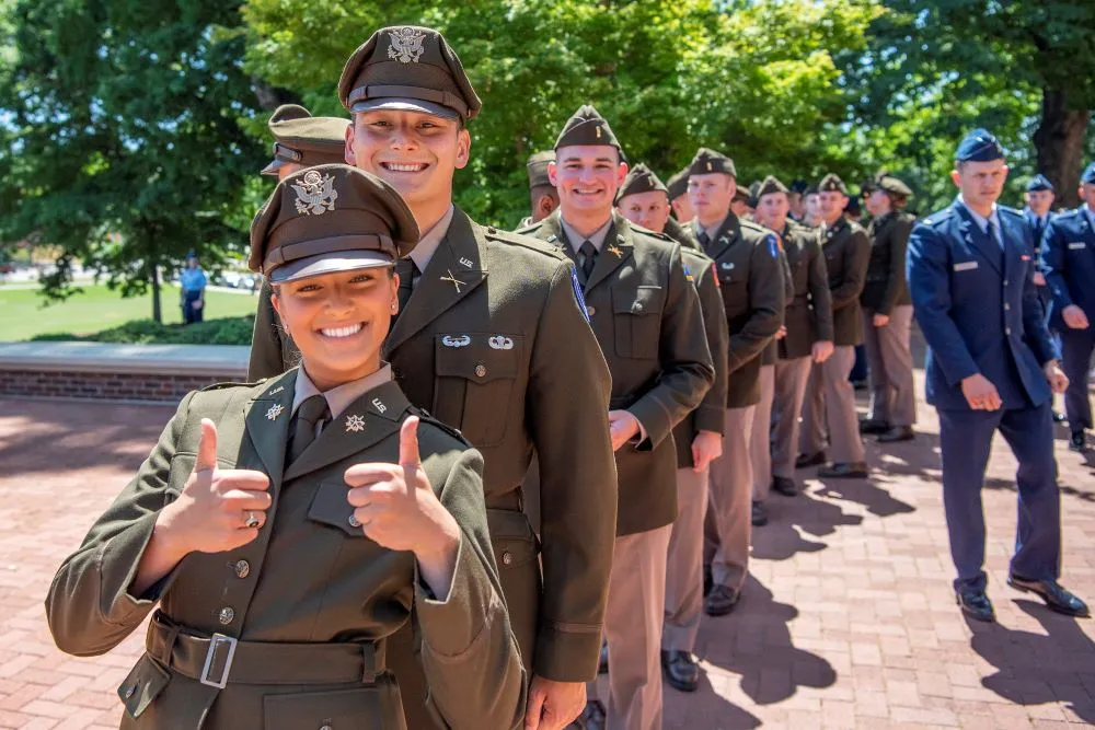 Newly commissioned Army second lieutenants smiling in line on commissioning day